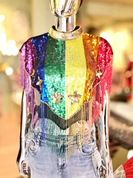 Farverig perlekappe med regnbuefarver og frynser, perfekt til Pride-fejringer.