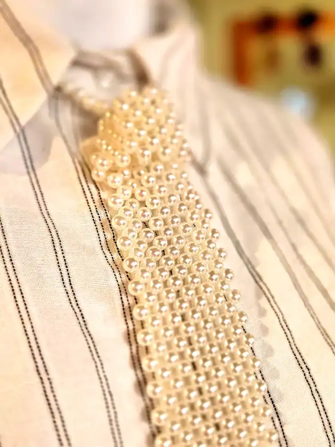 Perleslips halskæde i guld med elegante perler, perfekt til festlige anledninger.