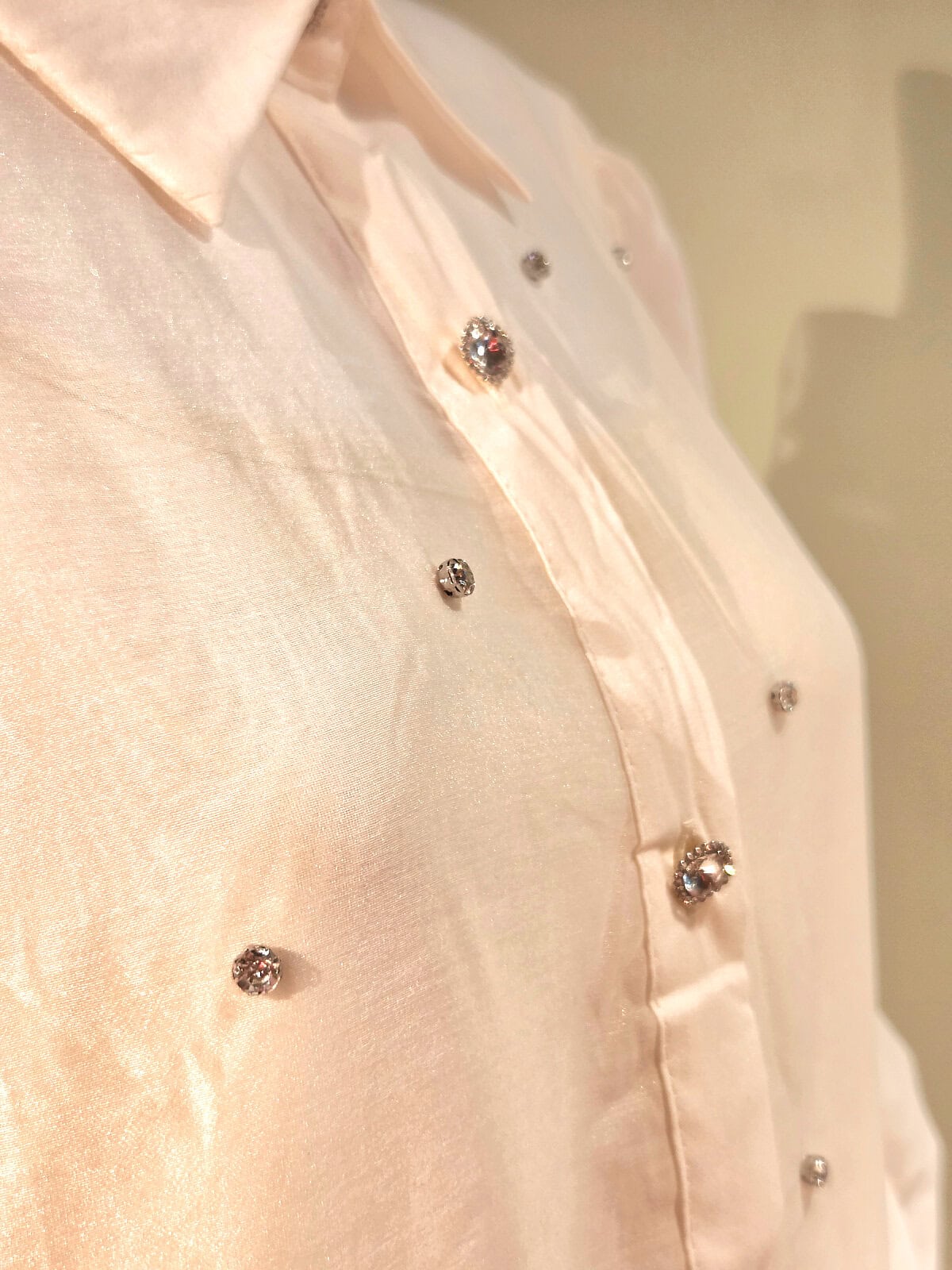 Hvid kjole med similiperler og elegant knapdetalje, perfekt til festlige lejligheder.