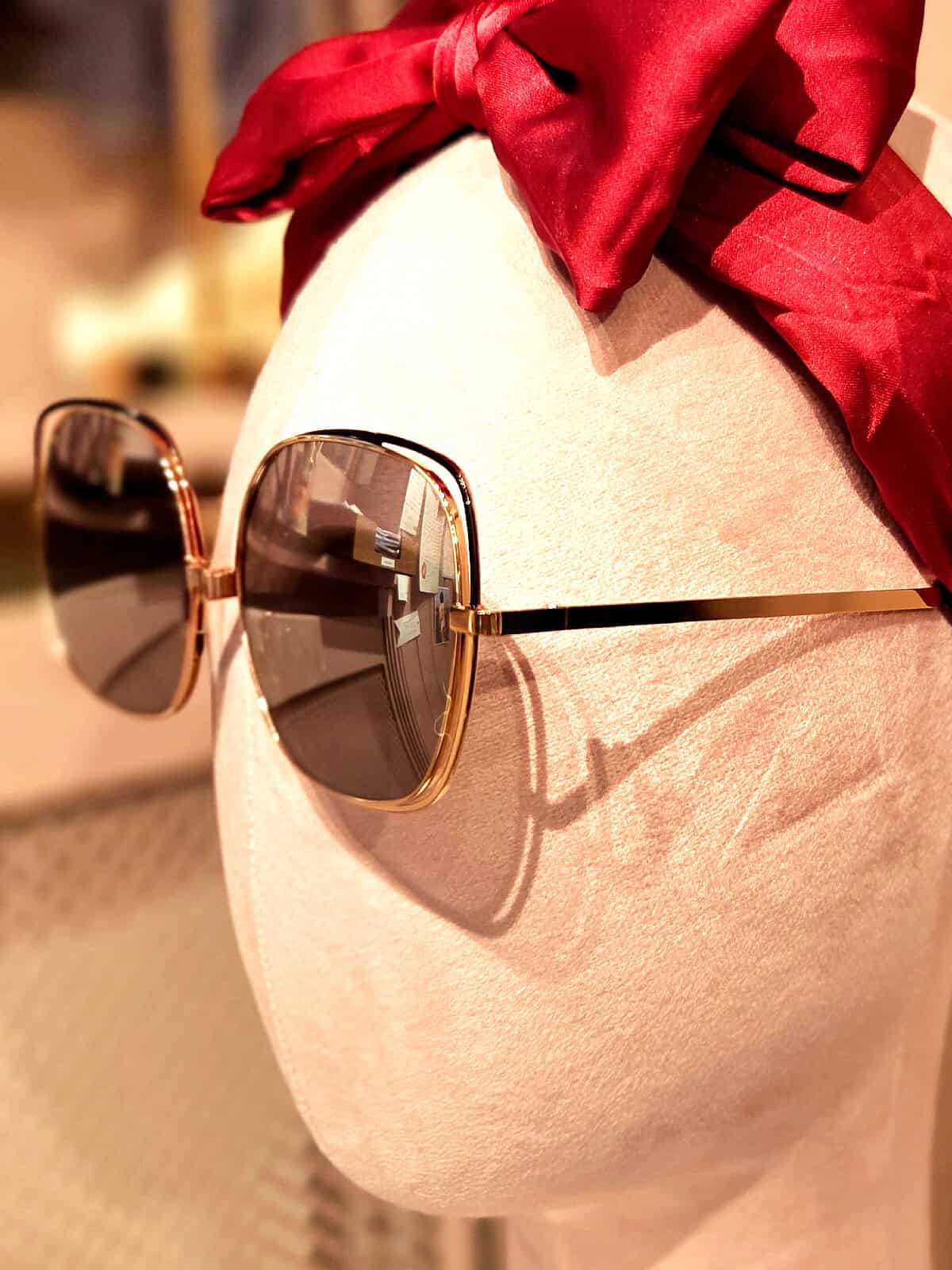 Solbriller med gyldne rammer og mørke glas, perfekt til sommerens solrige dage.