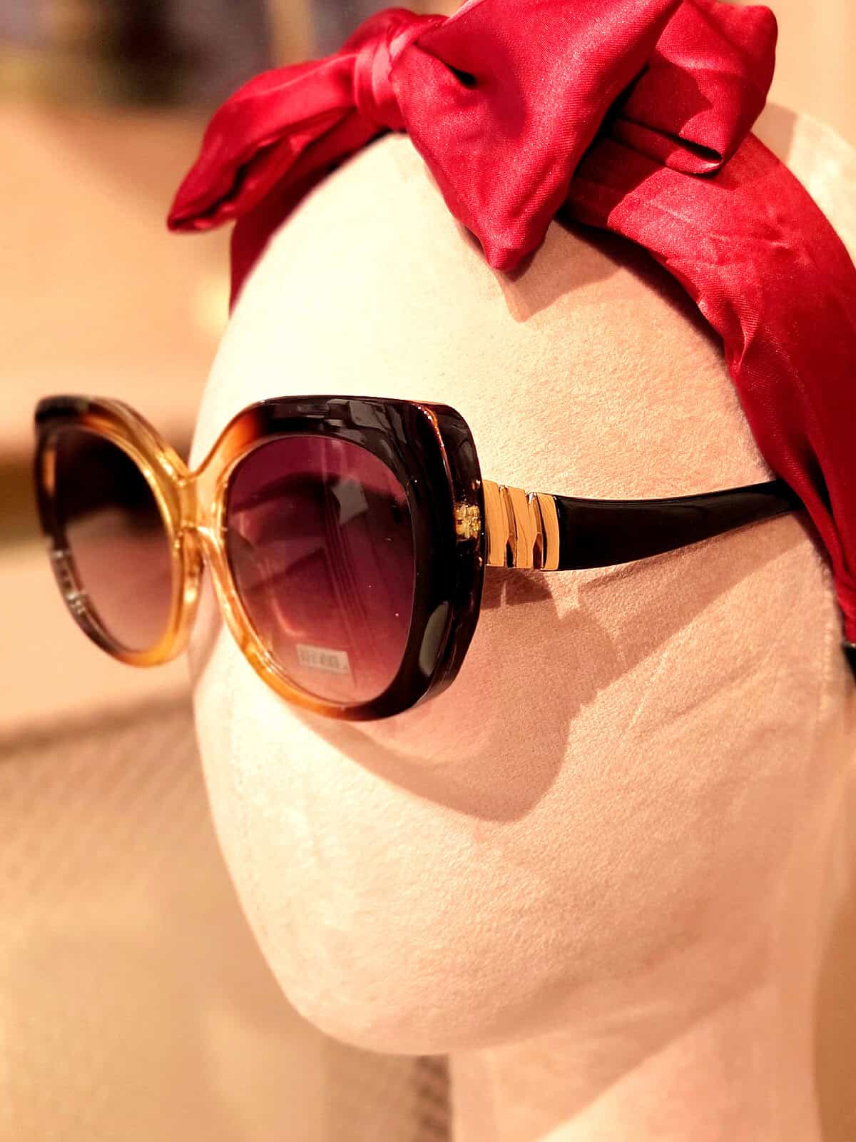 Solbriller med sort og guld ramme, perfekt til sommeren.