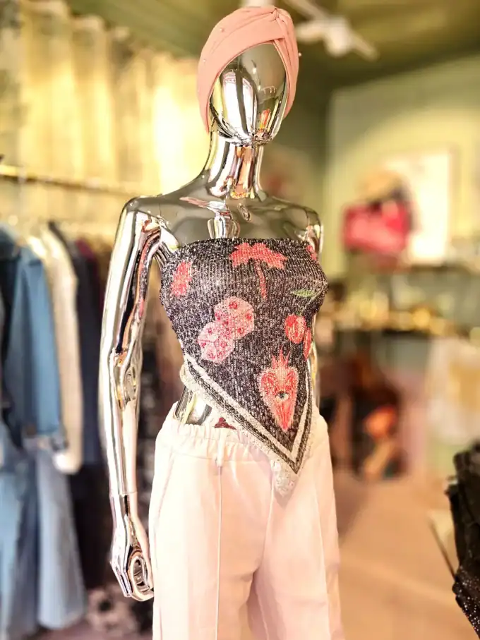 Elegant palliet bindetop med blomsterdesign, perfekt til festlige anledninger.