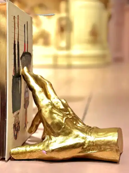 Guldskulptur af en hånd med skarabæ vægdekoration.