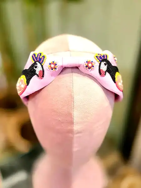 Sart lyserød hårbøjle med håndsyede unicorns og gule perler.