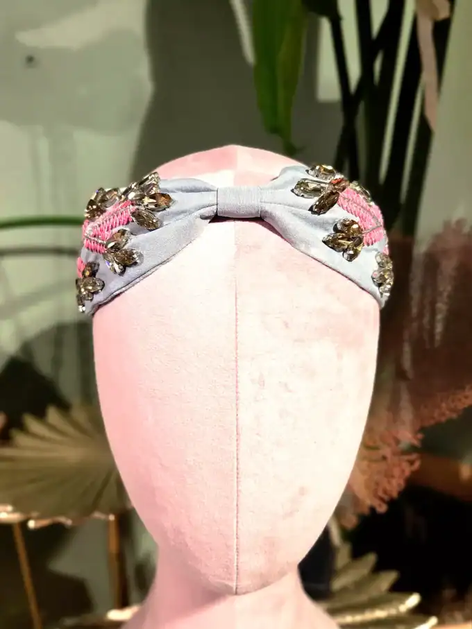 Sort hårbøjle med guld- og perleblomster, perfekt til elegante looks.